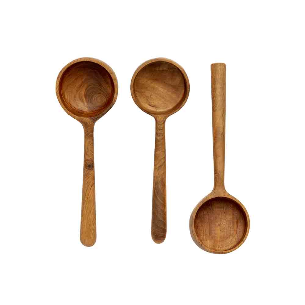 Three wooden measuring spoons with long handles, photographed from above on a plain white background.