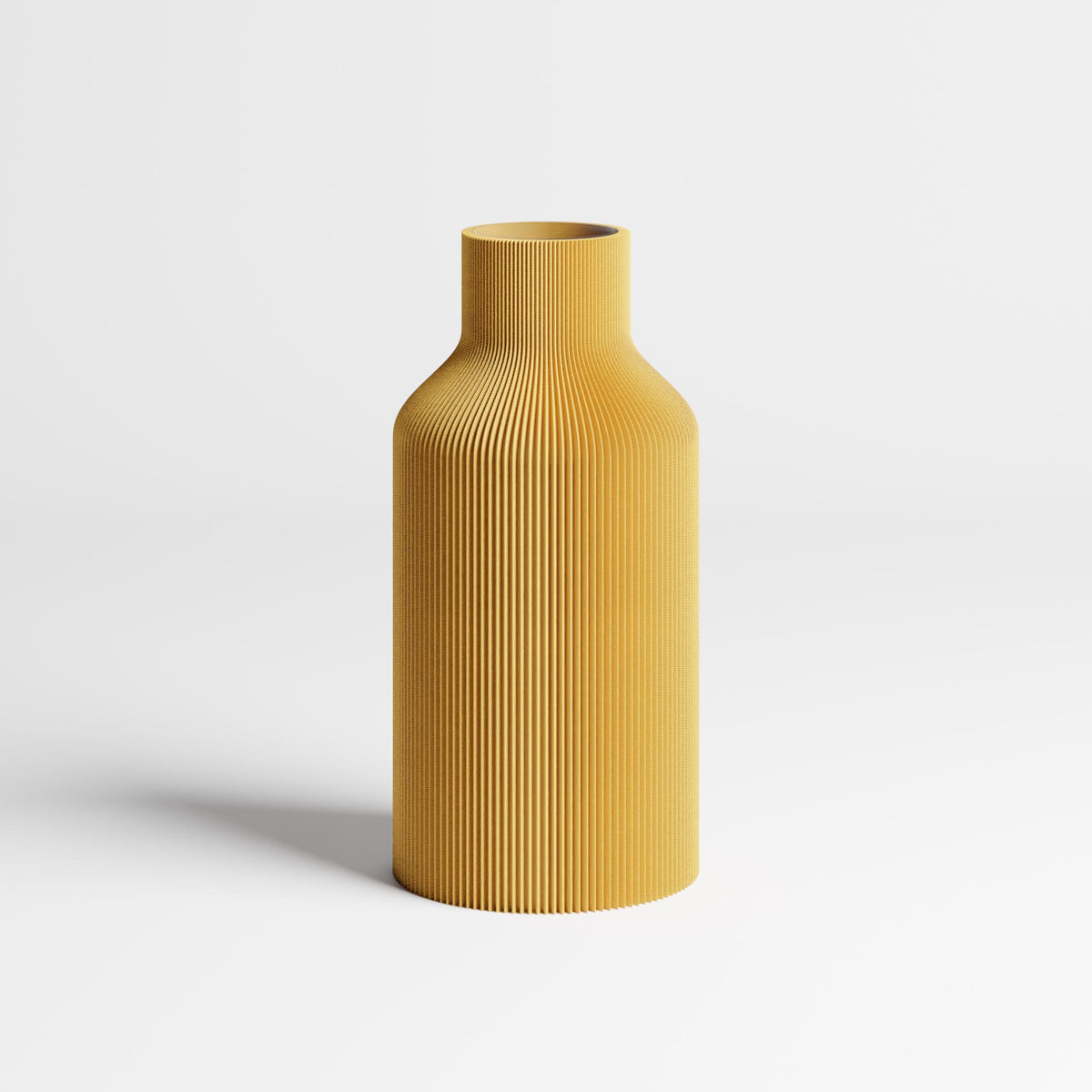 An mustard yellow ribbed vase with a flared neck, standing on a light gray surface against a white background.