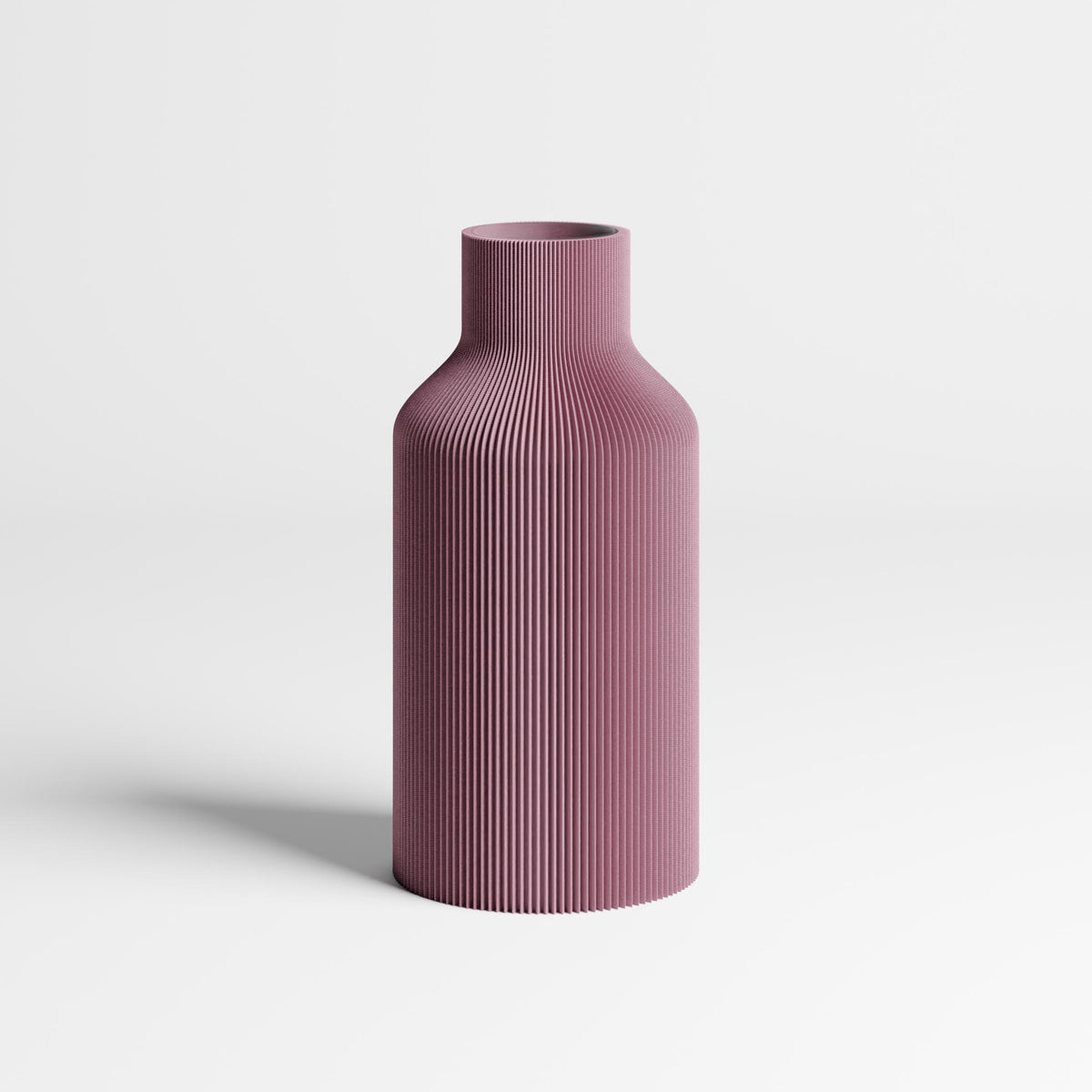 An dusky-purple ribbed vase with a flared neck, standing on a light gray surface against a white background.