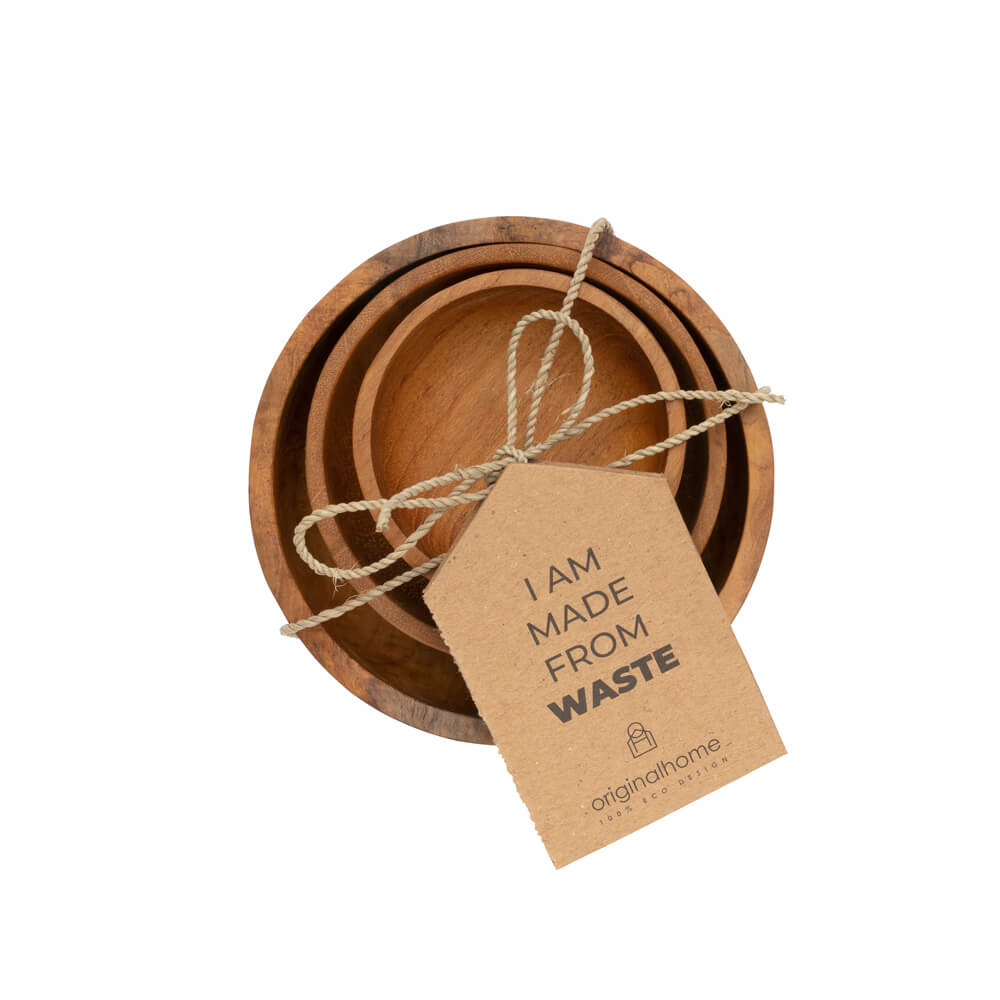 A set of 3 nested natural wooden bowls in varying sizes, tied together with a piece of twine and a kraft paper tag that reads 'I AM MADE FROM WASTE', shown from above on a solid white background.