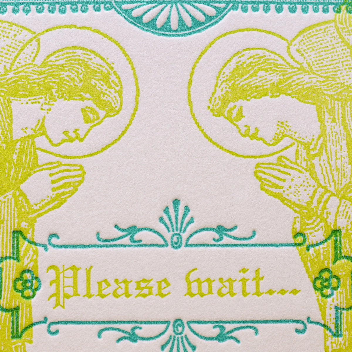 A close up of an art print card with an off white background, featuring two praying angel figures in yellow-green outline and teal decorative flourishes. The center reads 'Please wait'.