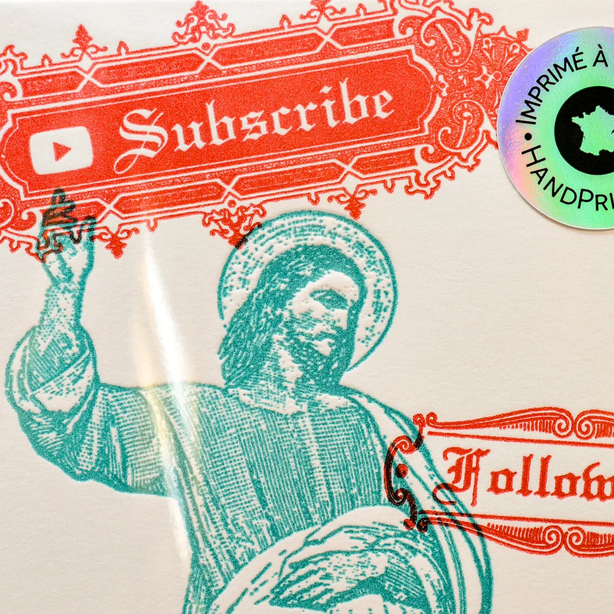 A close-up of a printed art card featuring a teal illustration of a religious figure raising his hand, with red decorative text reading 'Subscribe' and 'Follow Me' plus a circular holographic sticker on the outside protective sleeve.