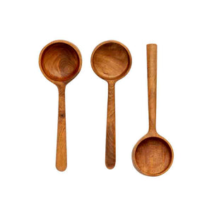 Three wooden measuring spoons with long handles, photographed from above on a plain white background.