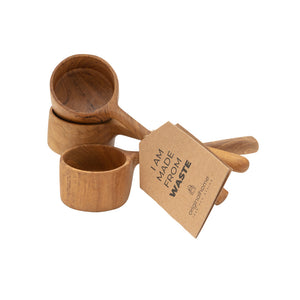Three wooden measuring scoops with long handles, shown with a kraft paper tag that reads 'I AM MADE FROM WASTE'. The scoops are photographed from the side on a plain white background.
