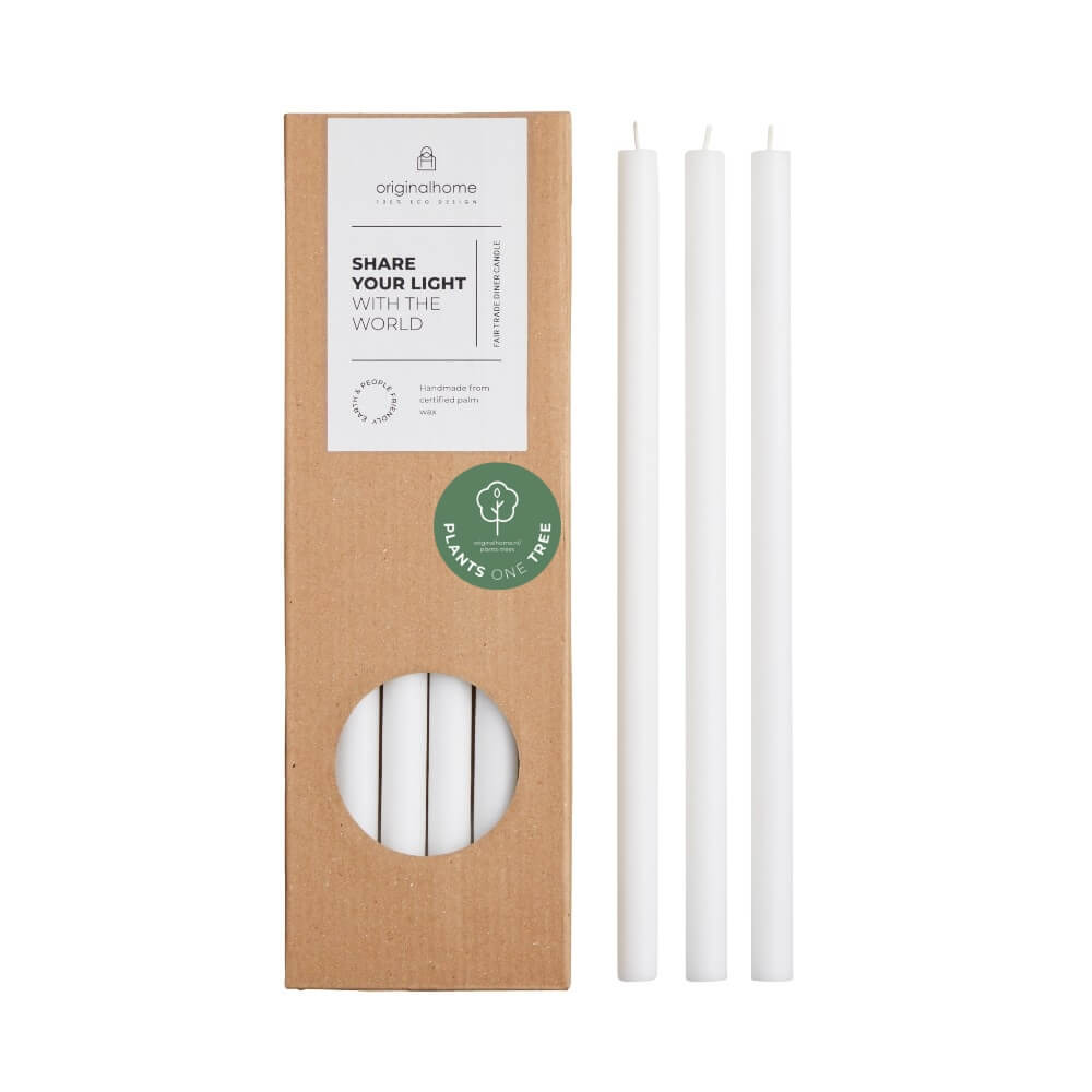 Three white thin candles displayed next to their brown kraft paper packaging box of 10 candles, which features a circular window showing the candles inside and a green 'Plants Based' sticker.
