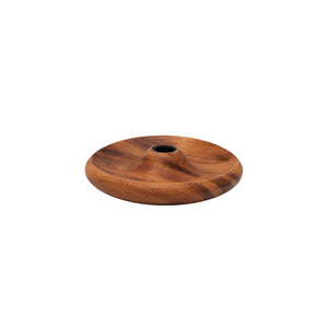 A round wooden candle holder with a central hole, showing natural brown wood grain, on a white background.