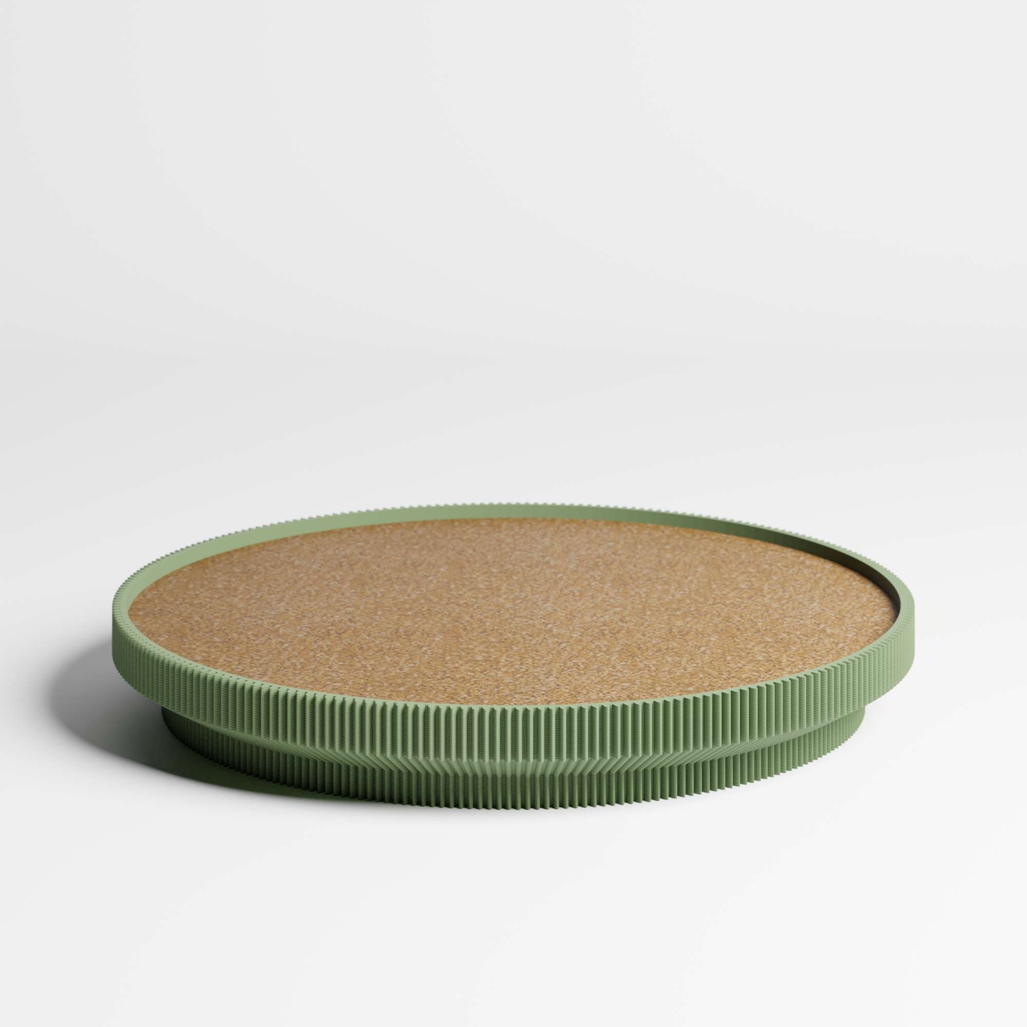 A round tray with a cork top and a olive green ribbed rim, photographed on a clean white studio background.