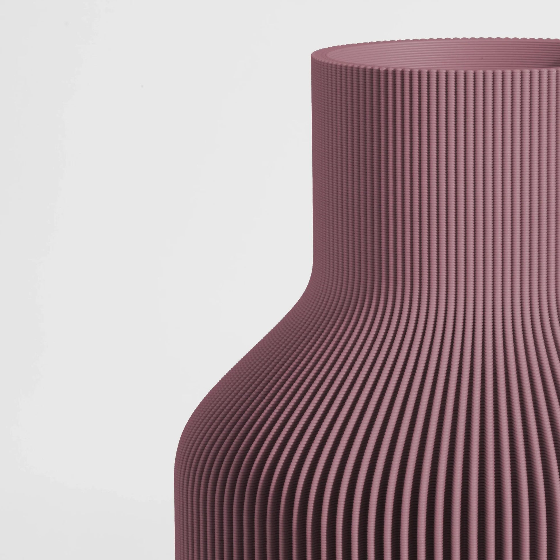 Close-up of a textured Ash Mauve vase on a light gray background.