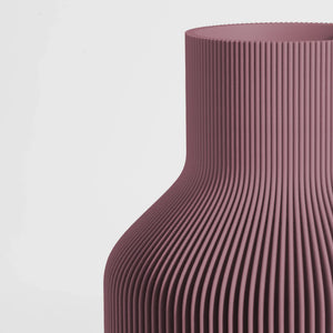 Close-up of a textured Ash Mauve vase on a light gray background.