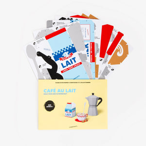 A flat lay of a coffee-and-milk craft paper kit showing printed templates and layered sheets above a light yellow envelope on a clean white background.