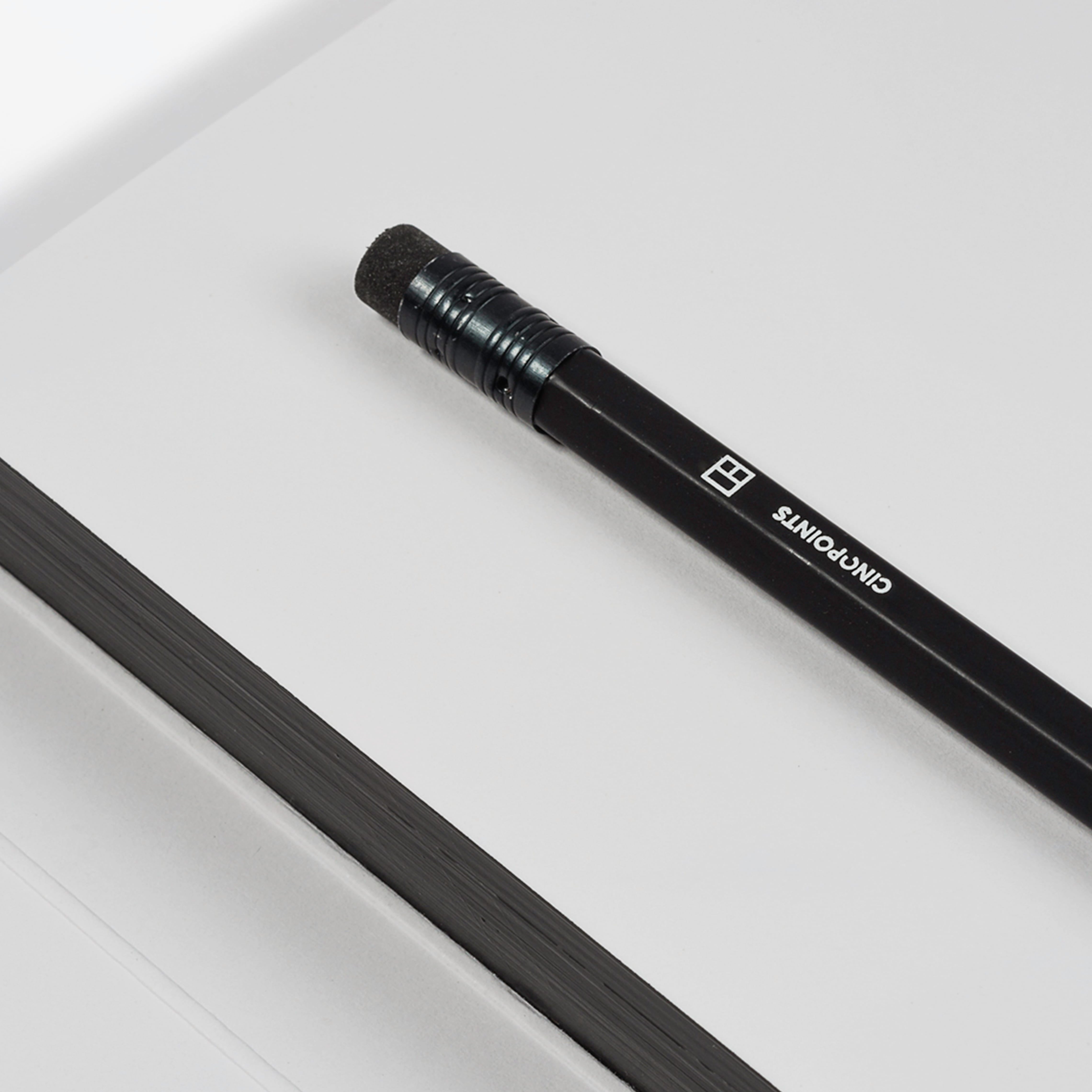 Black pencil with visible branding on a white surface