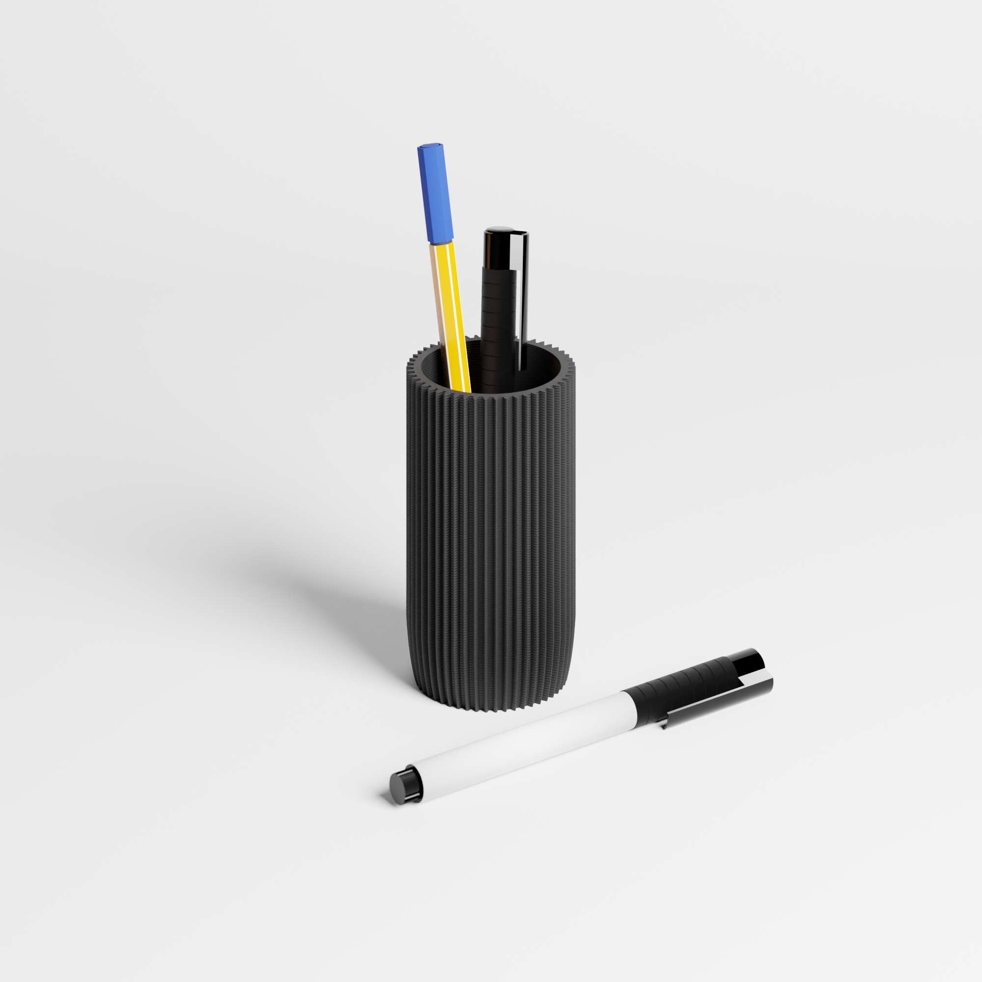 Black ribbed pen holder with three pens on a light gray background