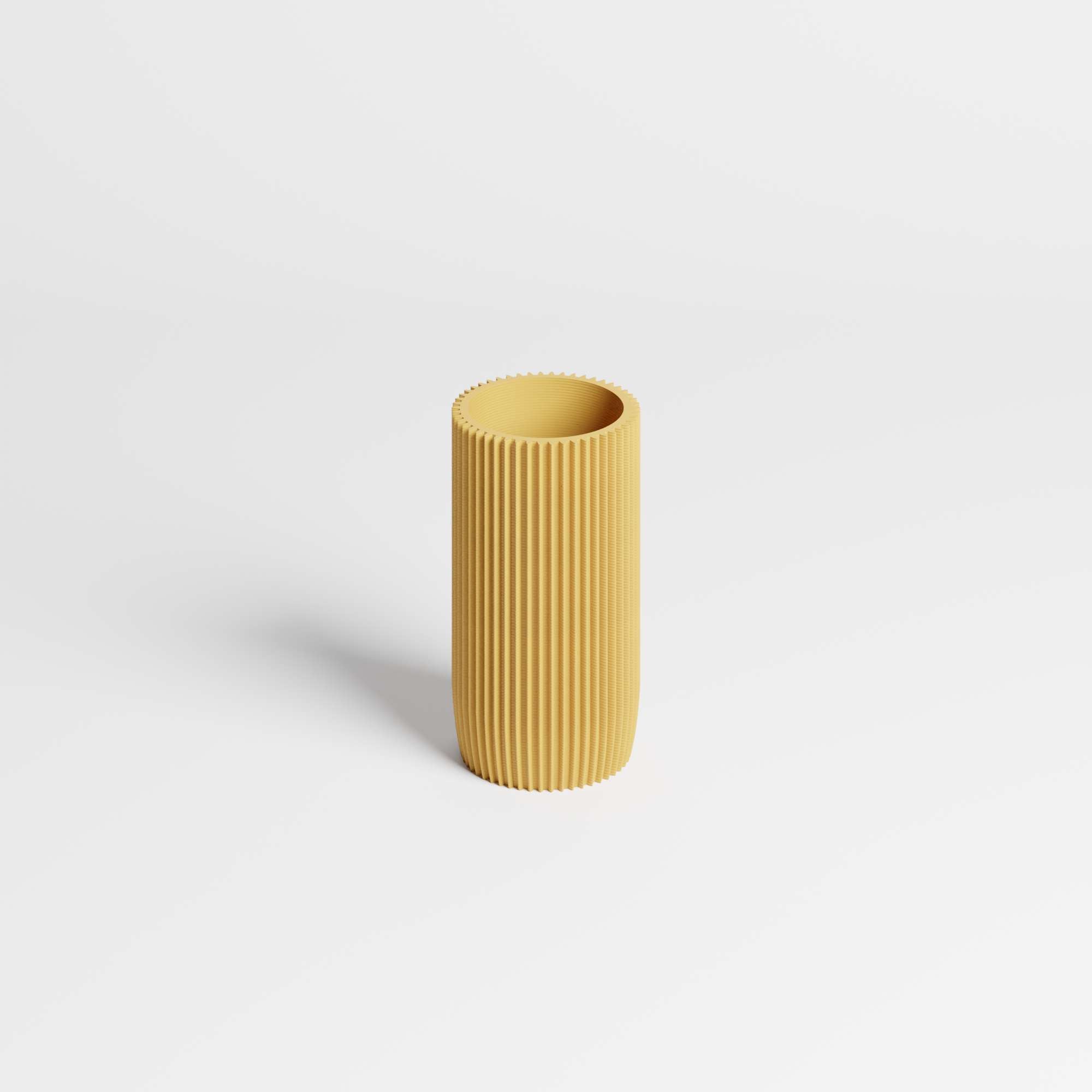 Yellow ribbed pen holder on a light gray background.