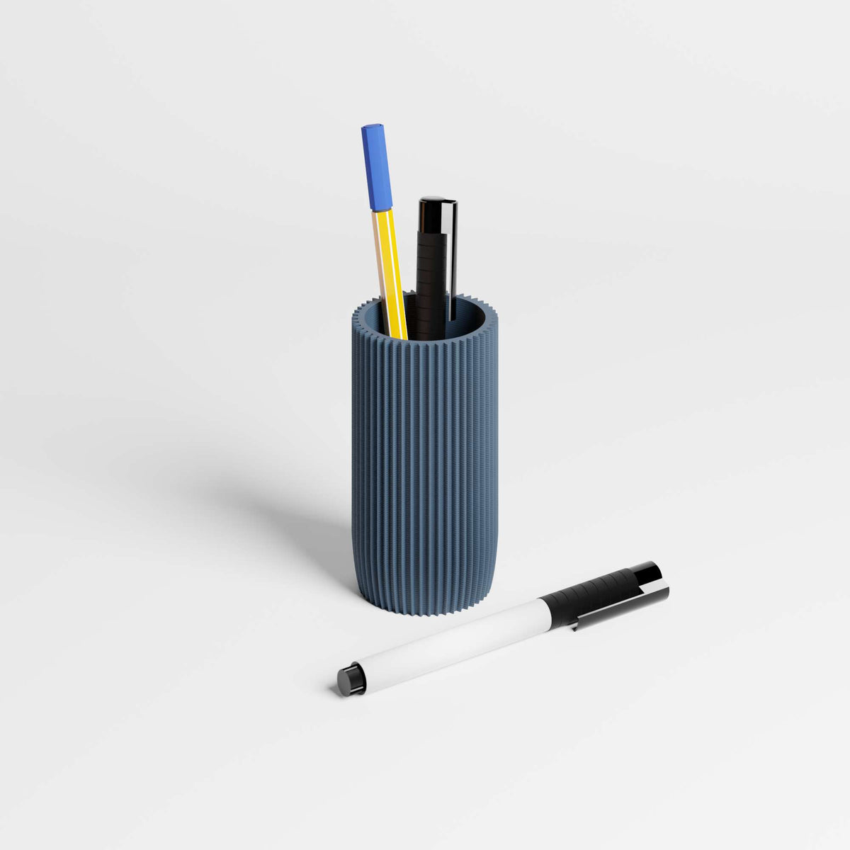 Navy Blue ribbed pen holder with pens on a light background