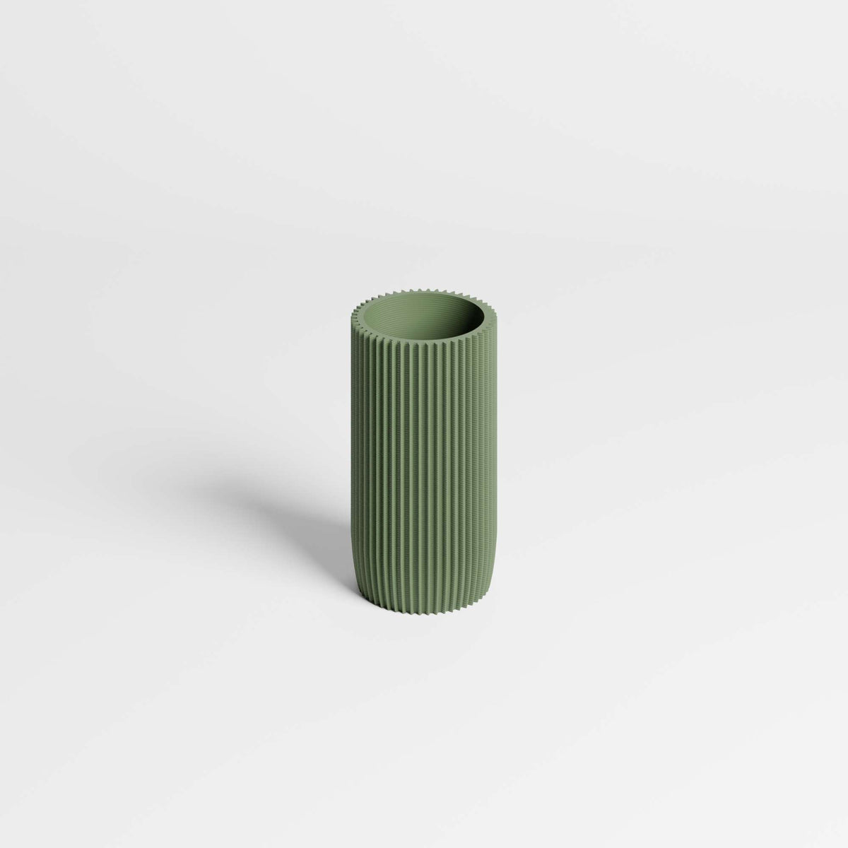 A minimalist olive green ribbed cylinder pen holder, standing upright on a clean white background.