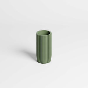 A minimalist olive green ribbed cylinder pen holder, standing upright on a clean white background.