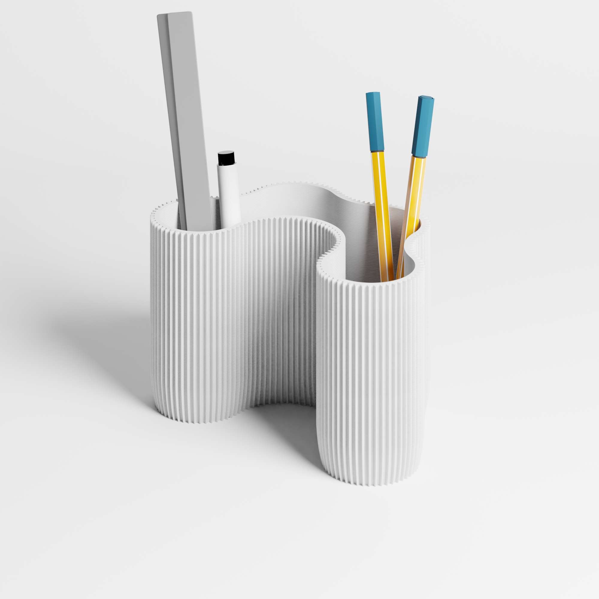 A flowing ribbed desk organiser in a white colour, shown with pens and a ruler inside it, on a clean white studio background.