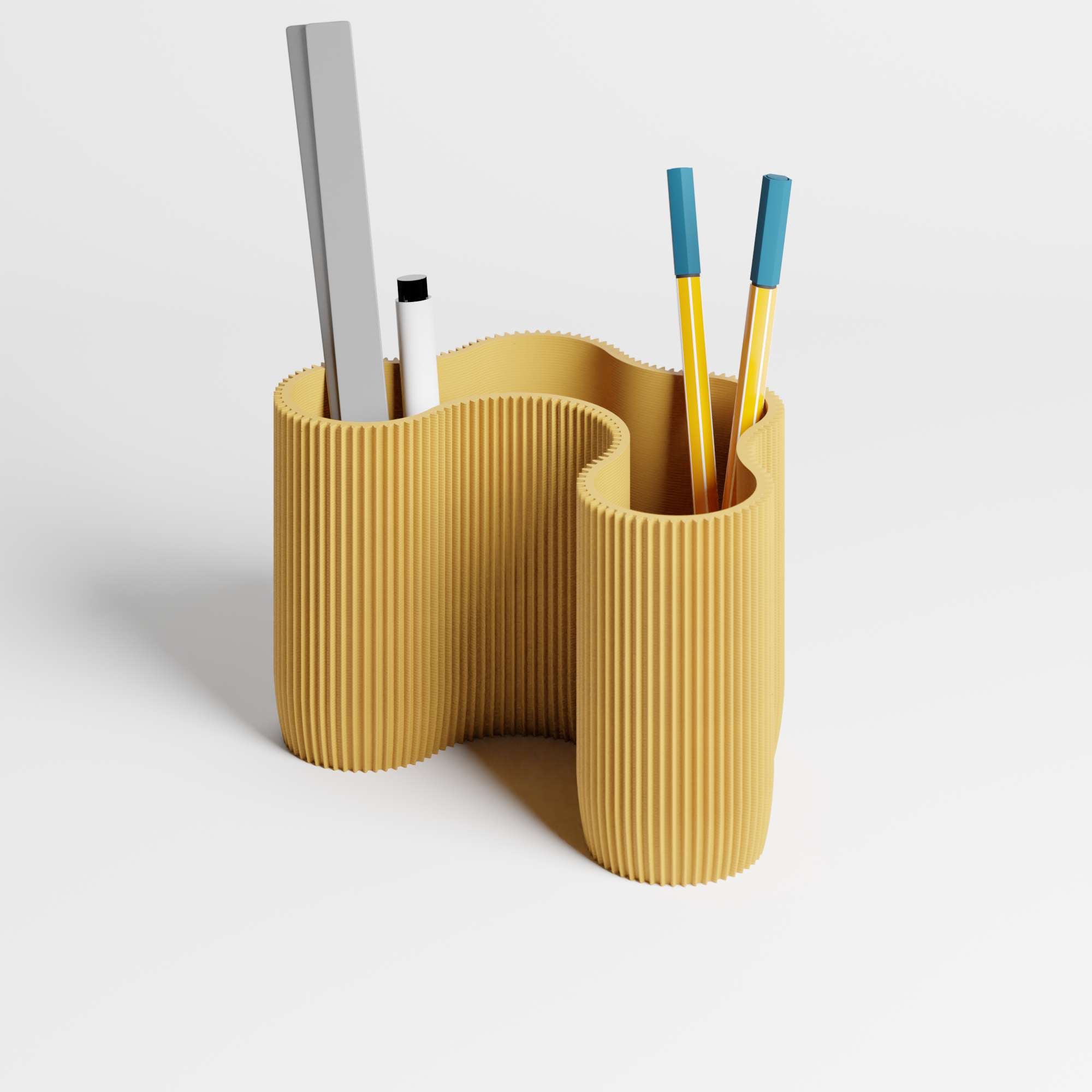 A mustard yellow ribbed desktop organiser  with a wavy, organic shape, with pens and a ruler inside it, shown on a clean white background.