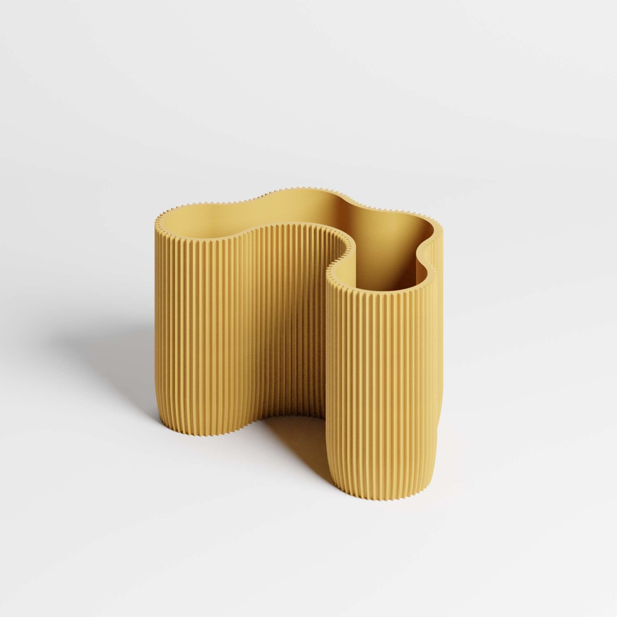 A modern mustard yellow ribbed desktop organiser  with a wavy, organic shape, shown on a clean white background.