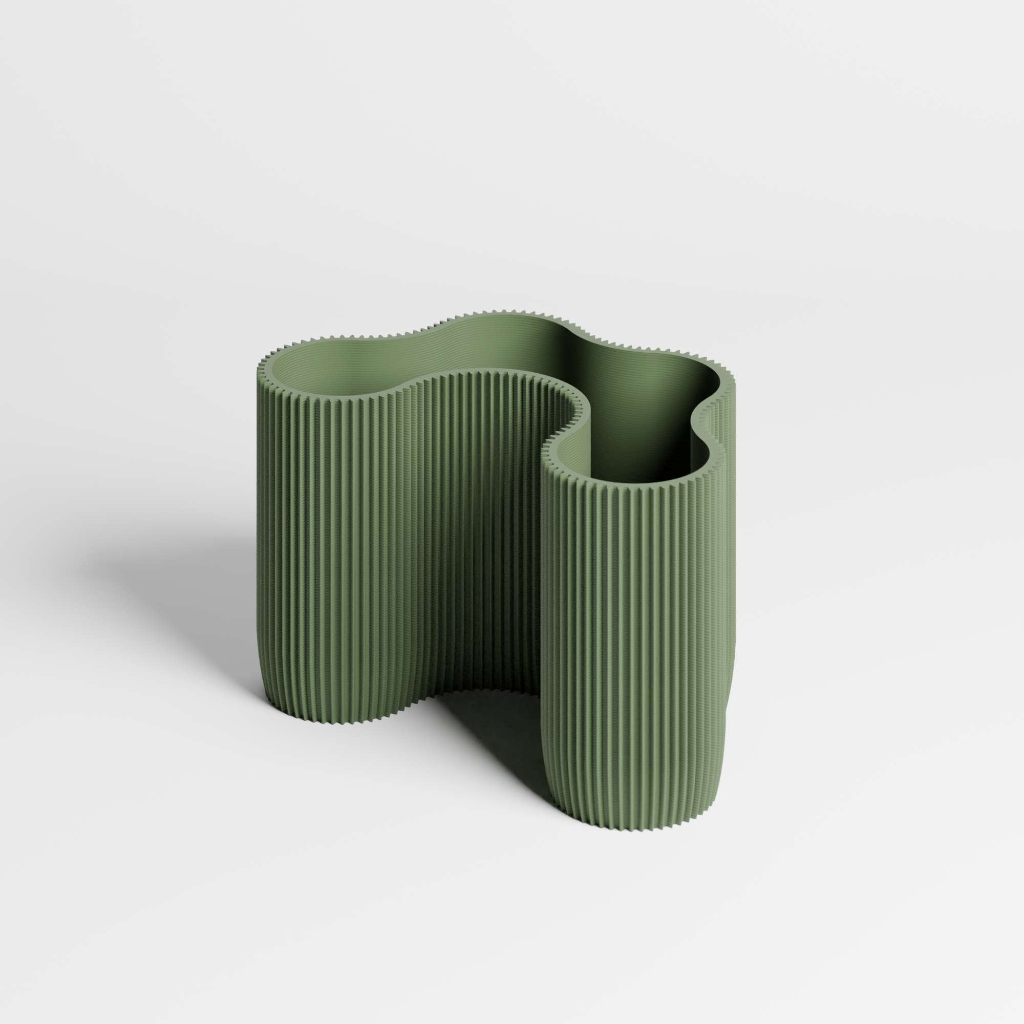 A sculptural ribbed desk organiser in a muted olive green colour, shown on a clean light gray studio background.