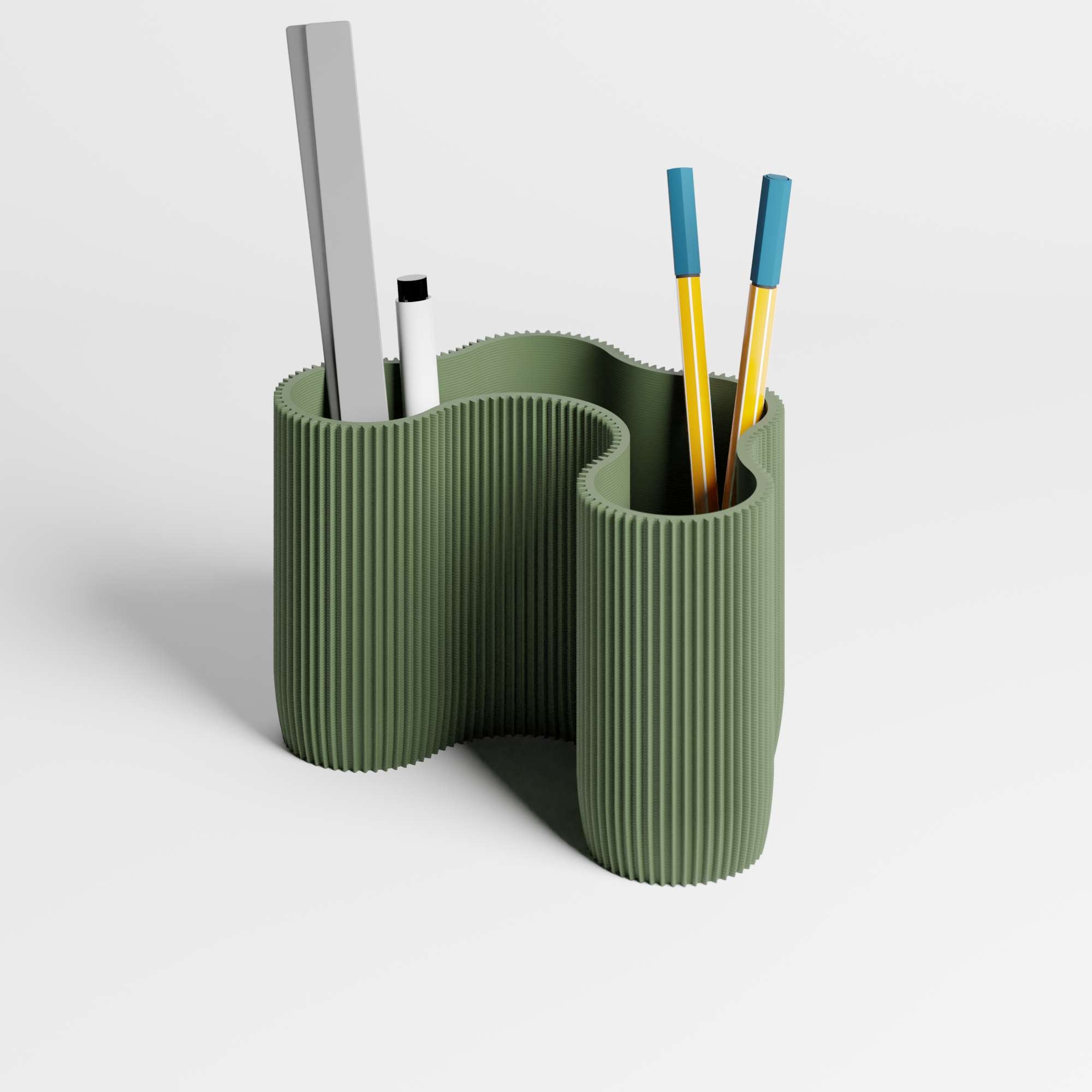 A sculptural ribbed desk organiser in a muted olive green colour, with pens and a ruler in it, shown on a clean light gray studio background.
