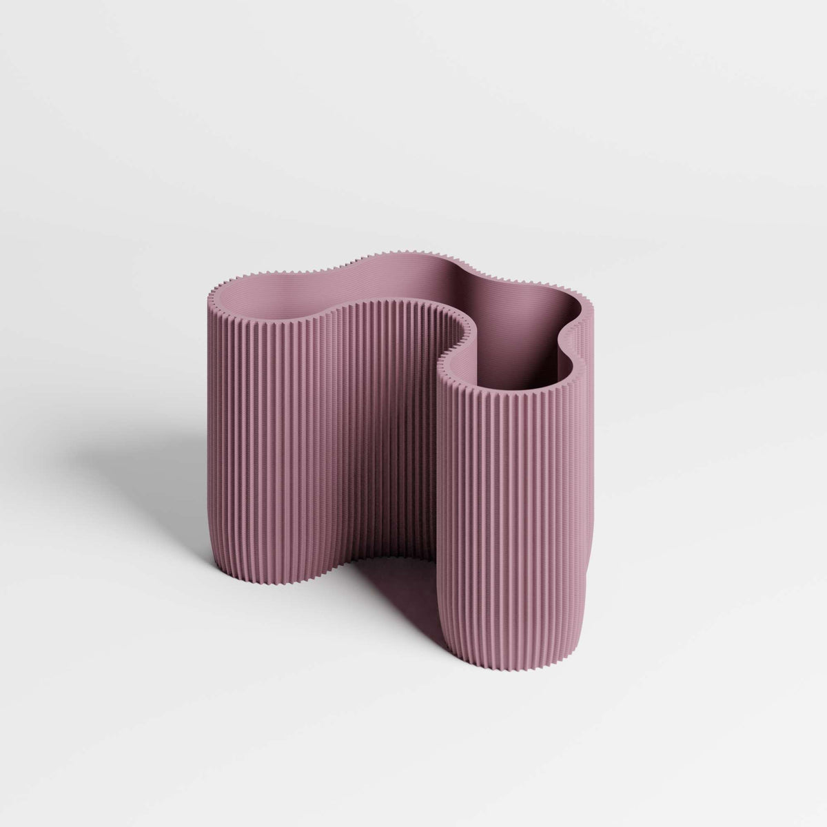 A modern four-compartment dusky-purple desk organiser with a wavy, ribbed design, on a white background.