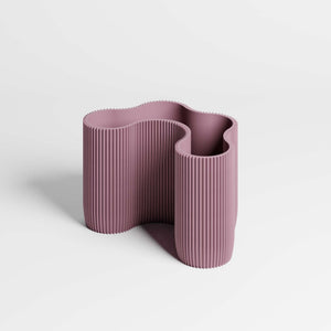 A modern four-compartment dusky-purple desk organiser with a wavy, ribbed design, on a white background.
