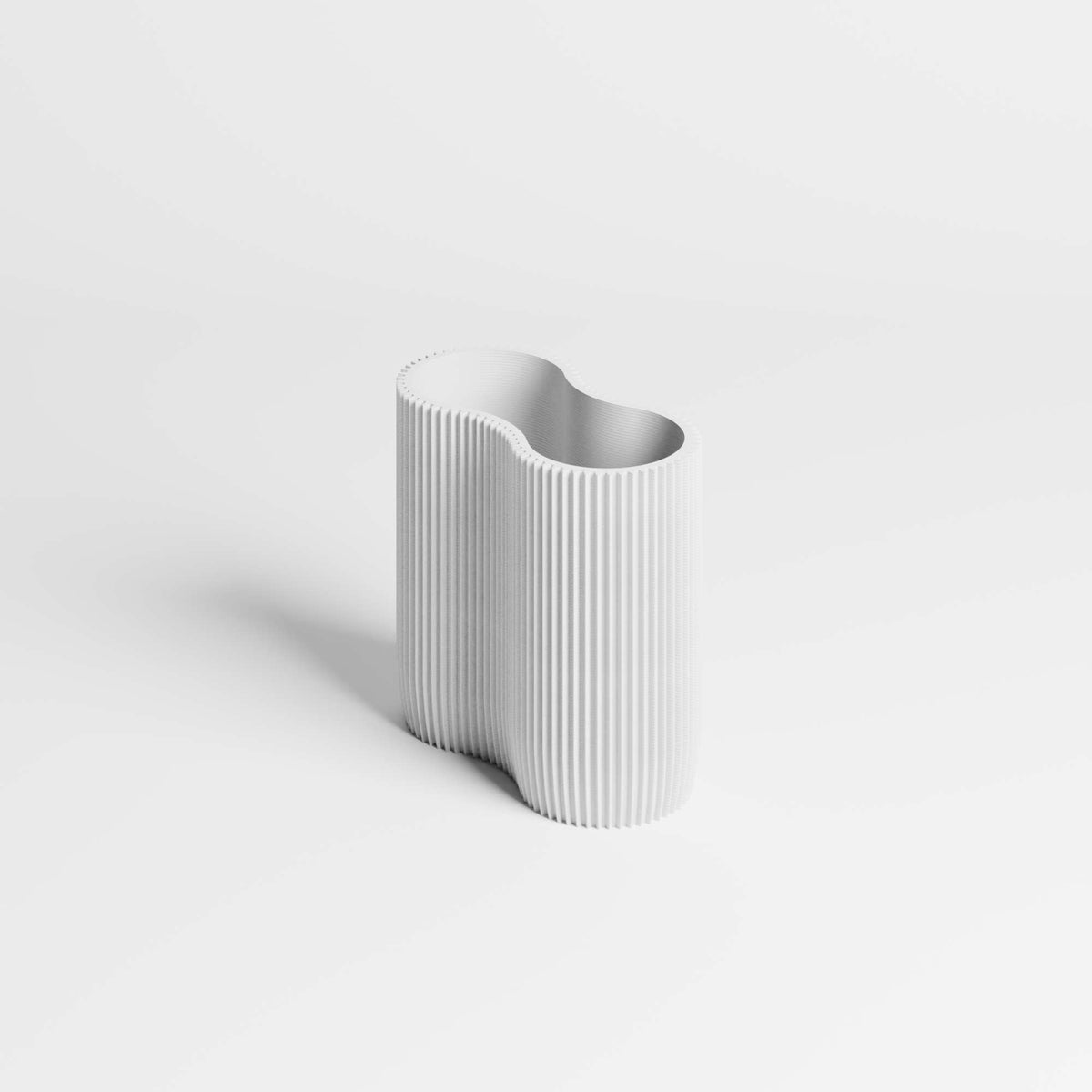 White cylindrical pen holder with ribbed texture on a light gray background