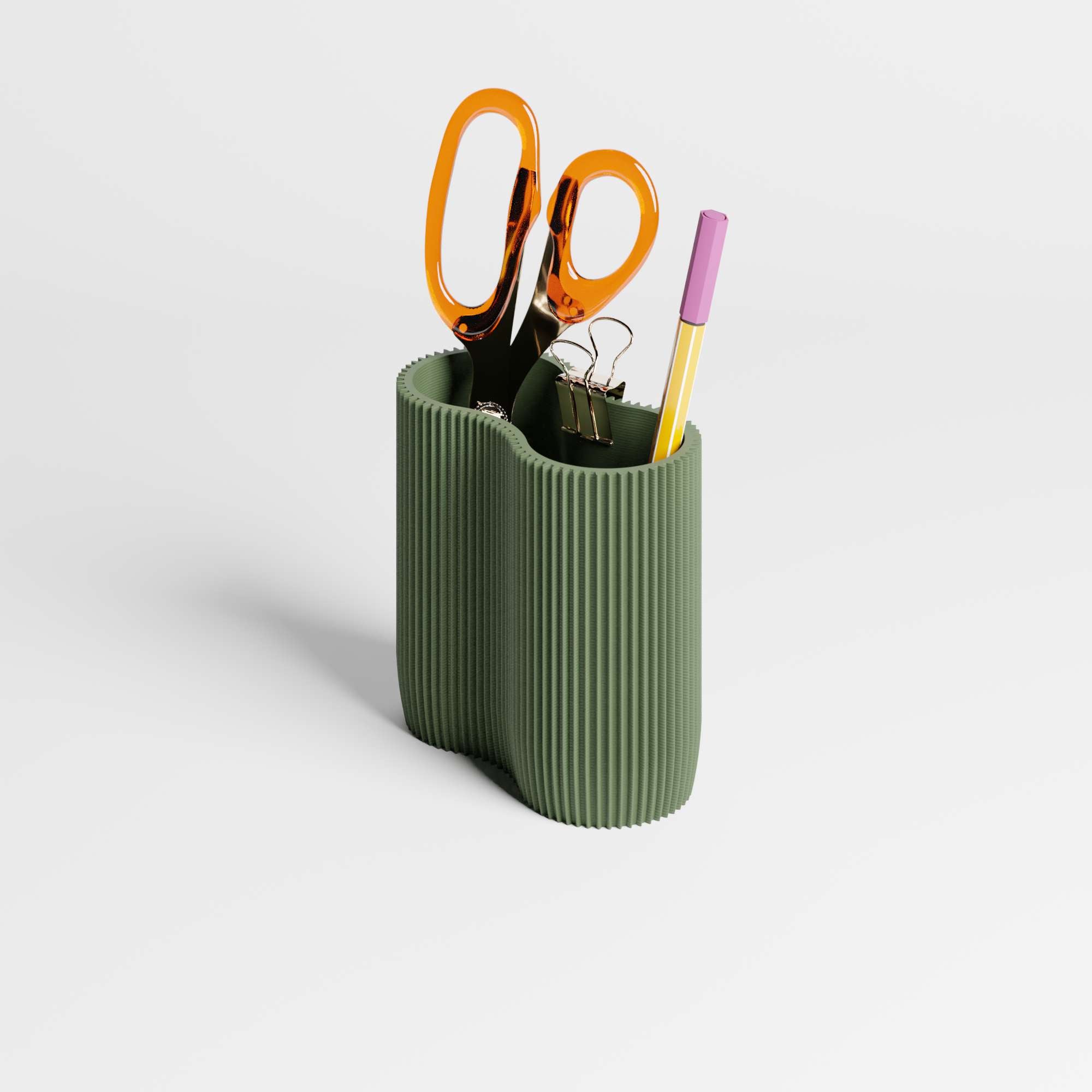 Green ribbed pen holder with office supplies on a light gray background