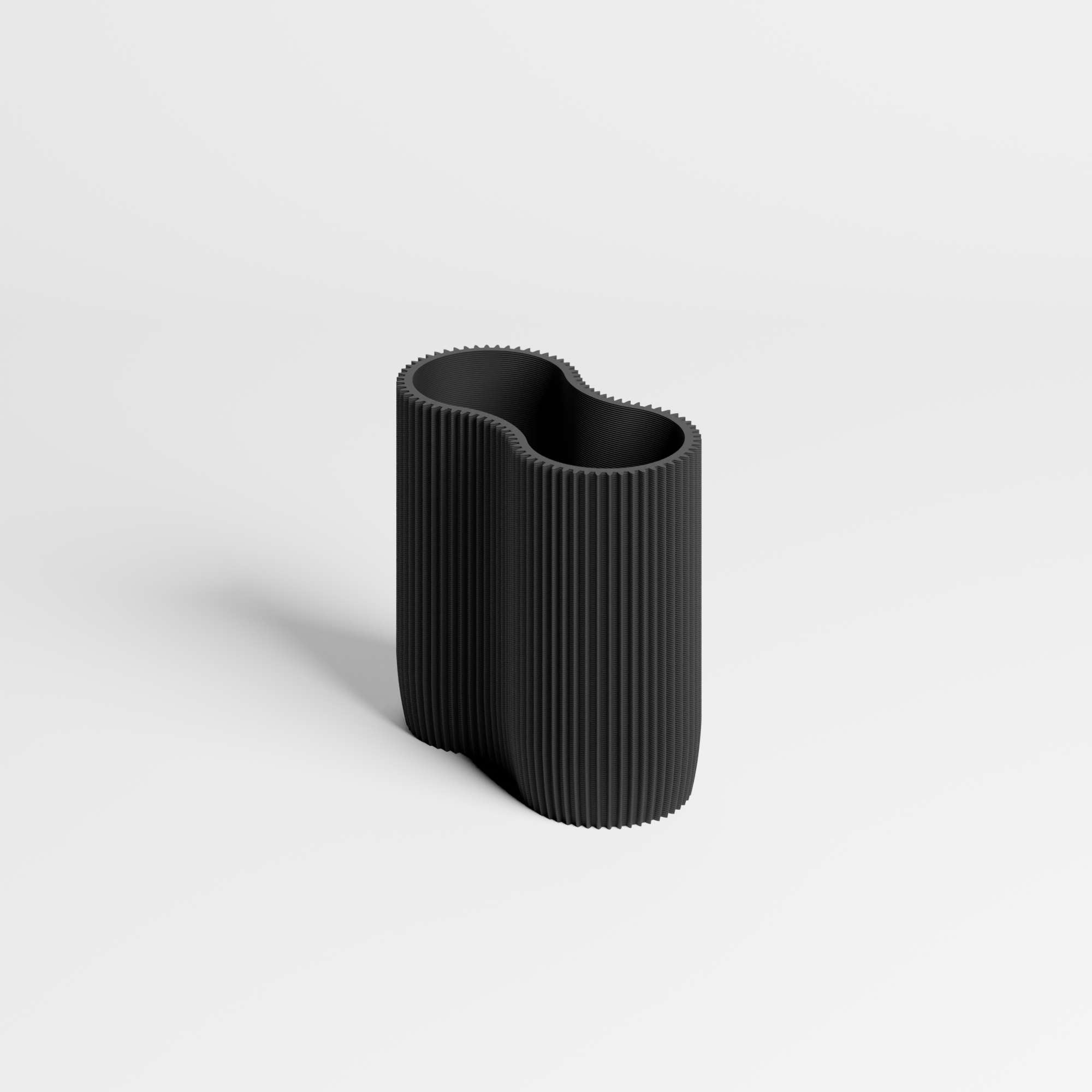 A modern, black ribbed pen holder with an organic, wavy silhouette, shown on a clean light gray background.