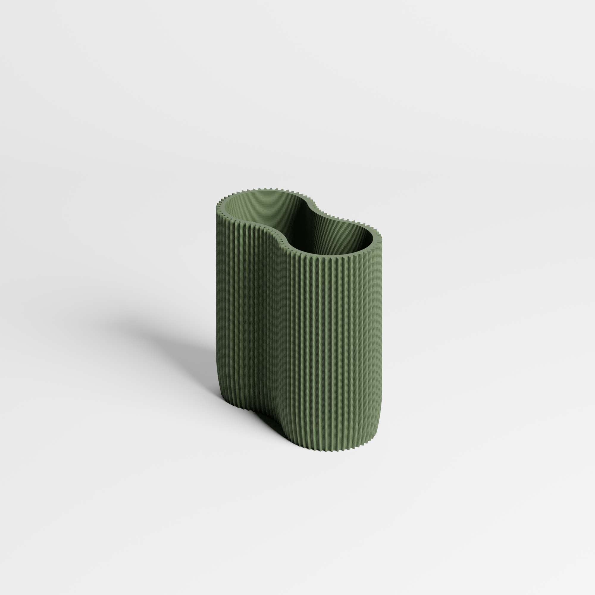 Green ribbed dual compartment pen holder on a light gray background