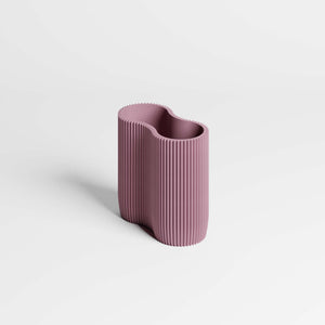 A modern, ribbed pen holder in a dusty mauve-purple colour, set against a clean white background with a soft shadow.