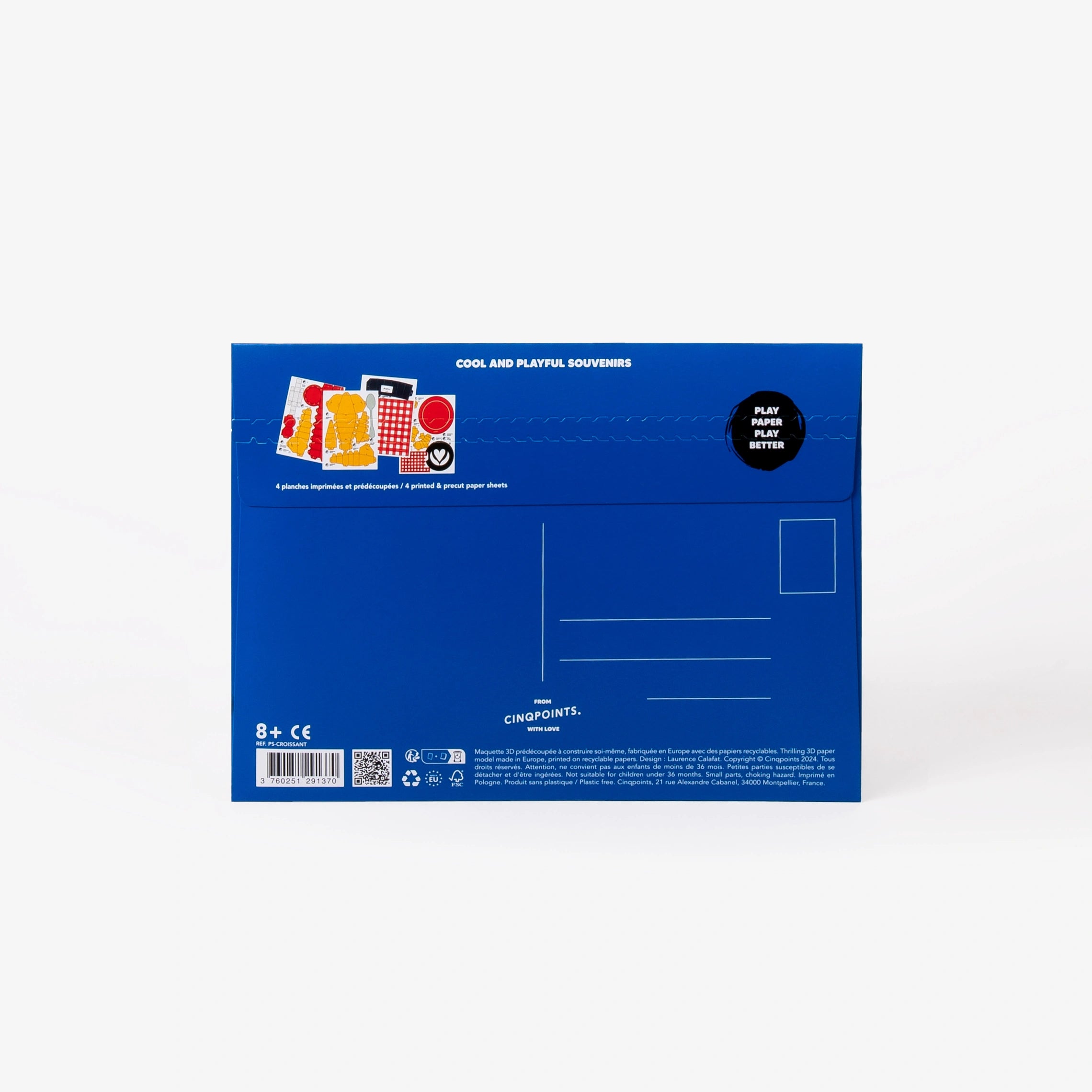 The back of a blue cardboard mailer envelope, featuring product details, address lines, stamp location, and a small graphic illustration, set against a clean white background.