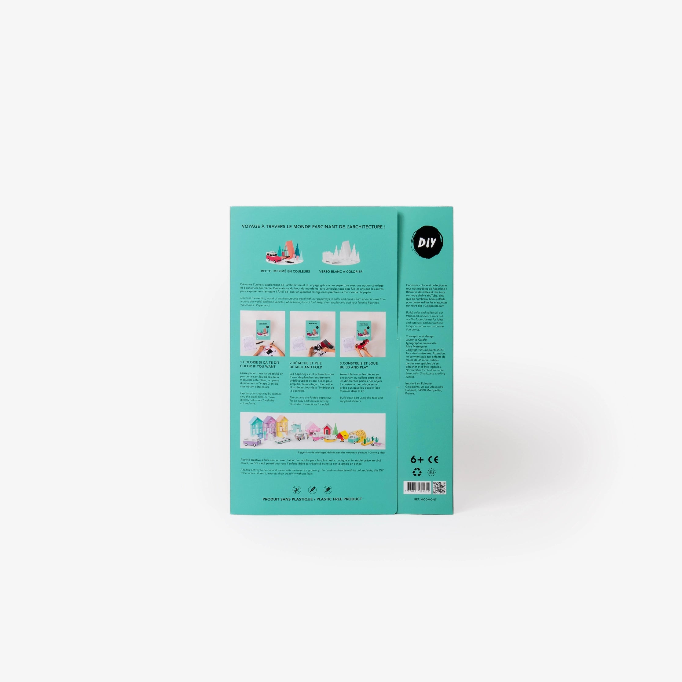 The back cover of a teal cardboard folder of a paper model kit stands upright on a clean white background, showing instructional text, and three small photos of hands working with white paper.