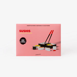 A pink cardboard envelope for a sushi paper model collector set, featuring illustrations of sushi pieces and a black-and-red chopsticks set, photographed on a clean white background.