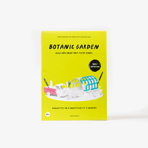 Botanic Garden paper model kit folder featuring a bright yellow cover standing upright against a clean white background. The cover shows a stylised illustration of a paper model greenhouse and van with paintbrushes and pencil.