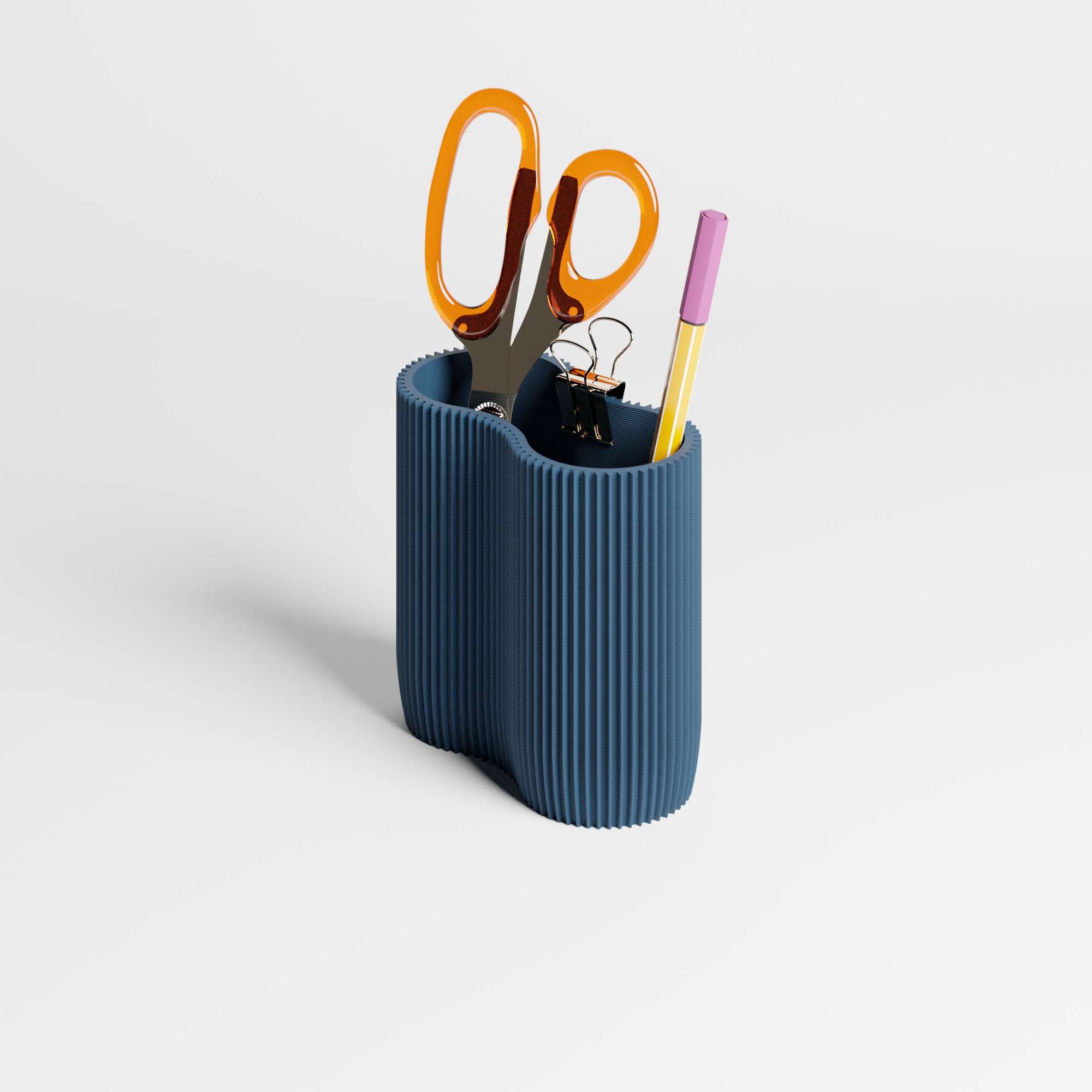 A ribbed blue pen holder or desk organizer on a light gray background, containing orange-handled scissors, a black binder clip, and a yellow pen.