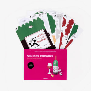 A DIY paper wine scene craft kit, shown with its pink packaging envelope and several fanned-out printed card templates on a clean white background.